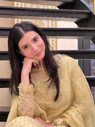 Ateeqa in a gold festive formal