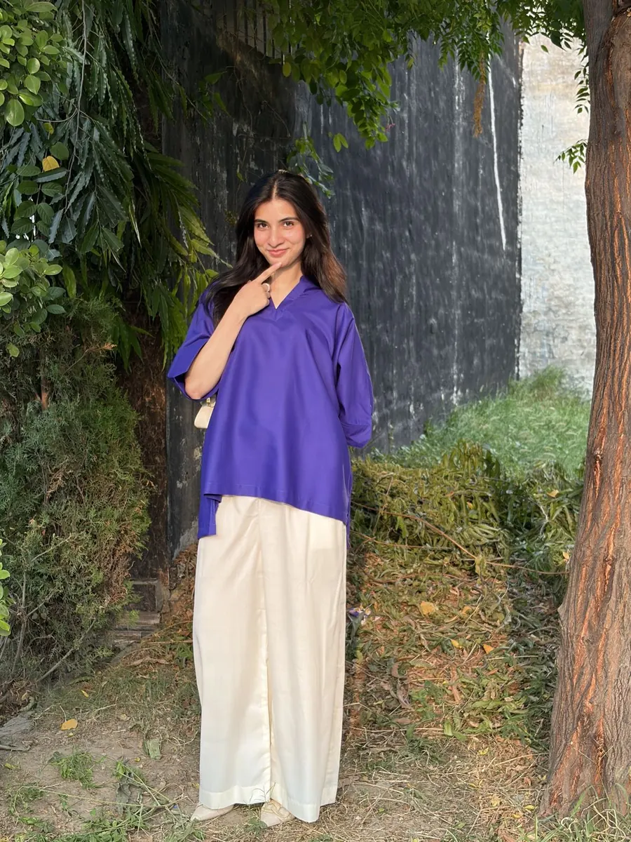 Ateeqa in a violet top and ivory trousers